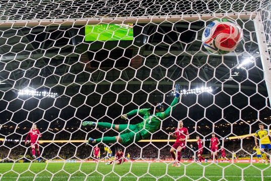 Anthony Elanga of Sweden scores the 1-0 goal against