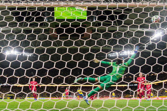 Anthony Elanga of Sweden scores the 1-0 goal against