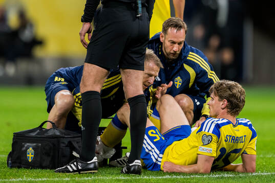 Carl Starfelt of Sweden receives medical attention