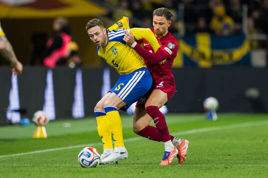 Gabriel Gudmundsson of Sweden and Matty Cash of Poland