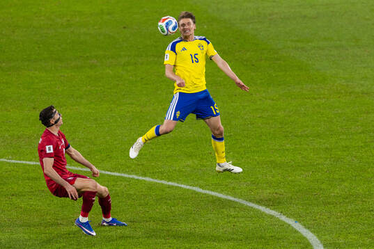 Carl Starfelt of Sweden and Robert Lewandowski of Poland