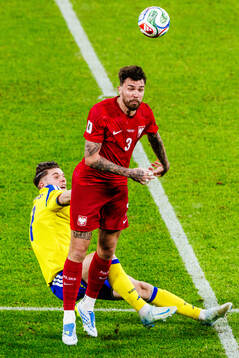 Viktor Gyökeres of Sweden and Przemyslaw Wisniewski of