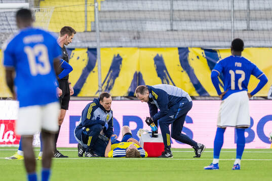 Noah Tolf of Sweden receives medical attention by medical