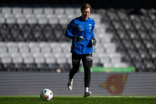 Goalkeeper Mathias Dyngeland of Brann warms up