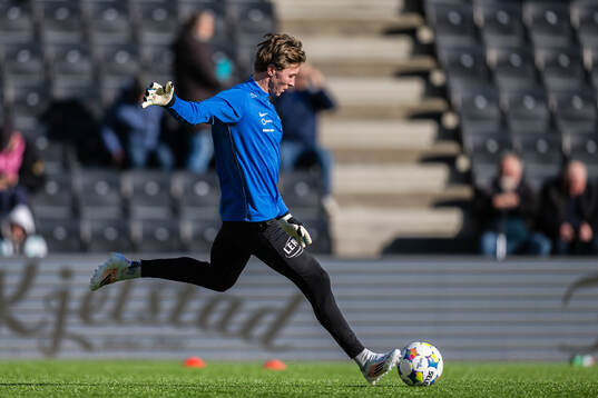 Goalkeeper Mathias Dyngeland of Brann warms up