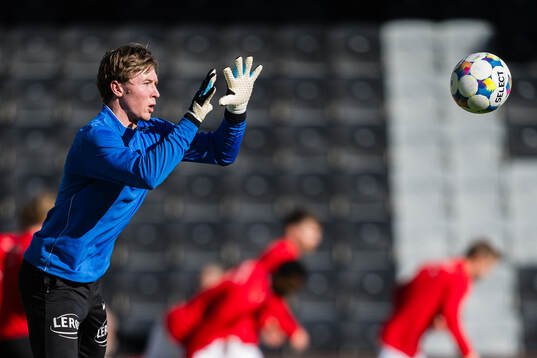 Goalkeeper Mathias Dyngeland of Brann warms up