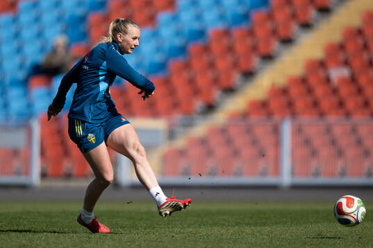 at a training session with the women's national football