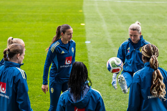 Rosa Kafaji and goalkeeper Jennifer Falk of the Swedish