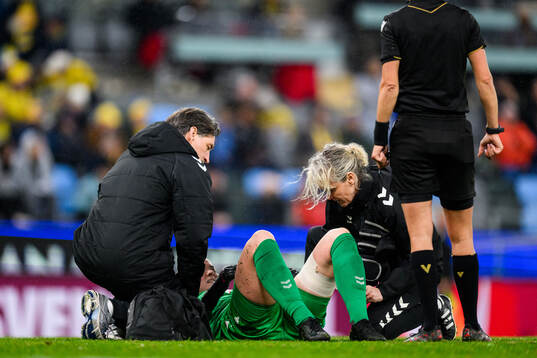 goalkeeper Freja Thisgaard of Denmark recieves medical