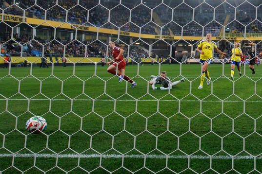 Janni Thomsen of Denmark scores 1-2 behind goalkeeper
