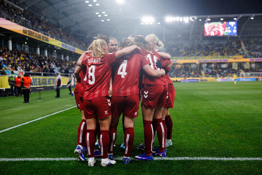 Janni Thomsen of Denmark celebrates with team mates