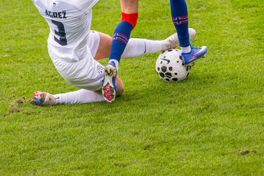Sara Agrež of Slovenia with a tackle
