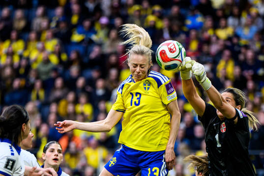 Amanda Ilestedt of Sweden and goalkeeper Milica Kostic of