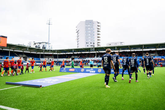 The teams enter the pitch