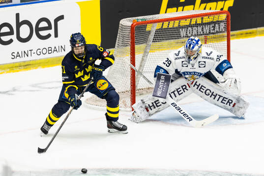 Viggo Björck of Sweden and goaltender Harri Säteri of