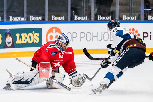 Goaltender Leonardo Genoni of Schweiz and Jesse Puljujärvi