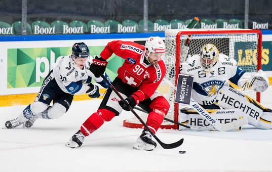 Roman Josi of Schweiz and Patrik Puistola and goaltender