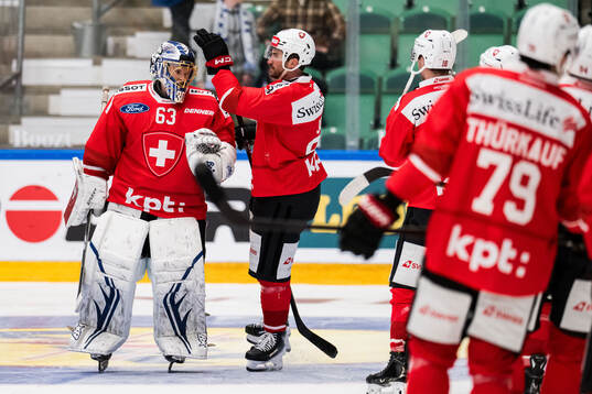 Goaltender Leonardo Genoni and Roman Josi of Schweiz