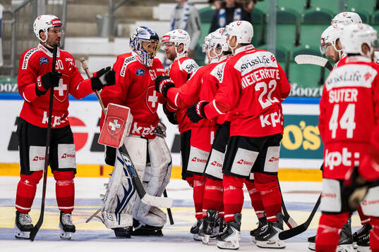 Goaltender Leonardo Genoni of Schweiz celebrates