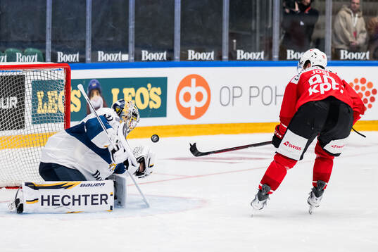 Goaltender Justus Annunen of Finland and Roman Josi of