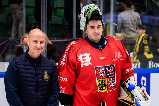 Goaltender Dominik Pavlat of Czech Republic is awarded