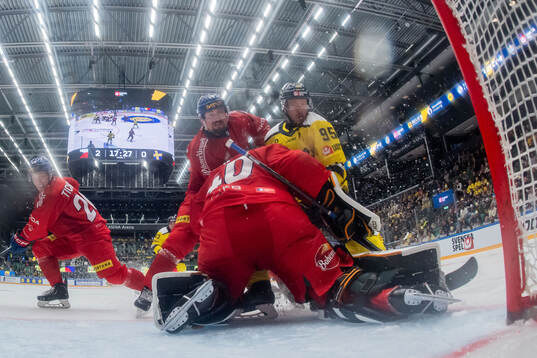 Jacob De La Rose of Sweden against goaltender Dominik