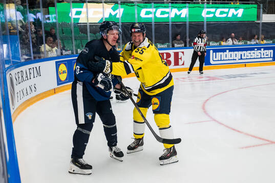 Esa Pirnes of Finland Legends and Niklas Kronwall of Sweden