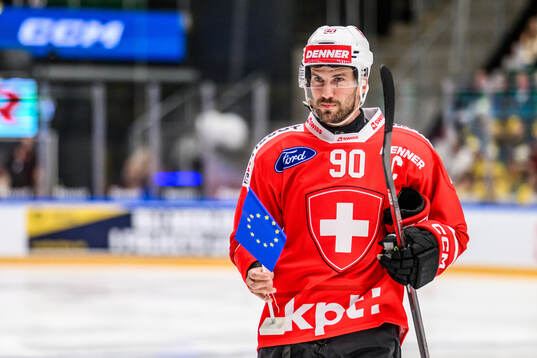 Roman Josi of Schweiz with a flag of the European Union