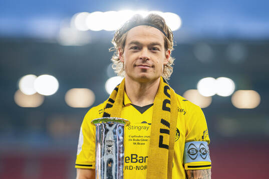 Patrick Berg of Bodø/Glimt with the trophy
