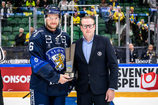 Alexander Barkov of Finland receives the trophy from Magnus