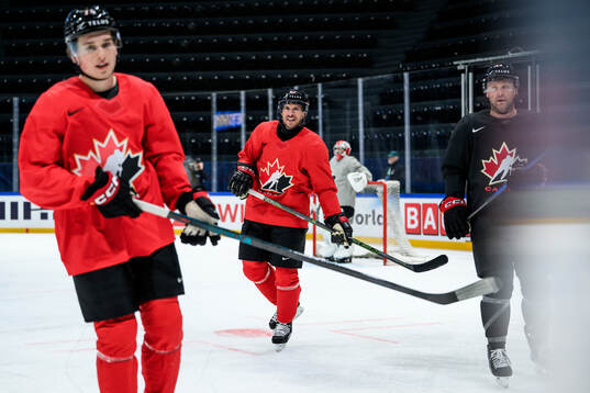 Macklin Celebrini and Sidney Crosby of Canada at a practice