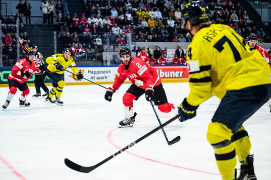 Dylan Demelo of Canada and Rasmus Asplund of Sweden