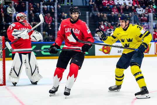 Evan Bouchard of Canada and Jakob Silfverberg of Sweden