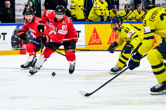 Dylan Holloway of Canada and Viggo Björck of Sweden