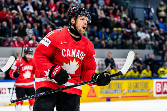 Dylan Holloway of Canada celebrates 3-2