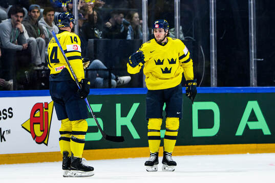 Mattias Ekholm and Linus Karlsson of Sweden celebrate 3-3