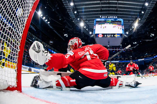 Jet Greaves of Canada saves a shot from Albert Johansson of