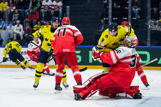 Linus Karlsson of Sweden and goaltender Mads Søgaard of