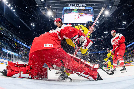 goaltender Mads Søgaard of Denmark and Lucas Raymond of