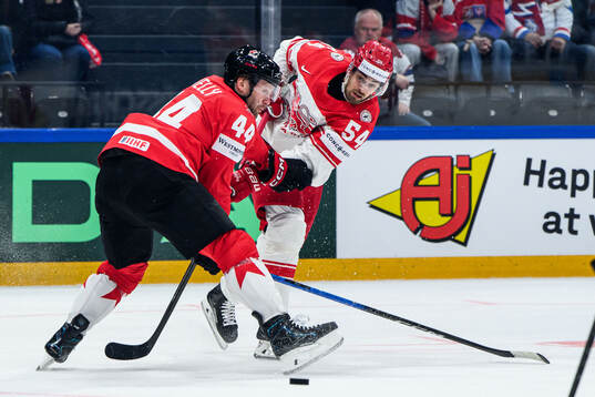 Morgan Rielly of Canada and Felix Scheel of Denmark