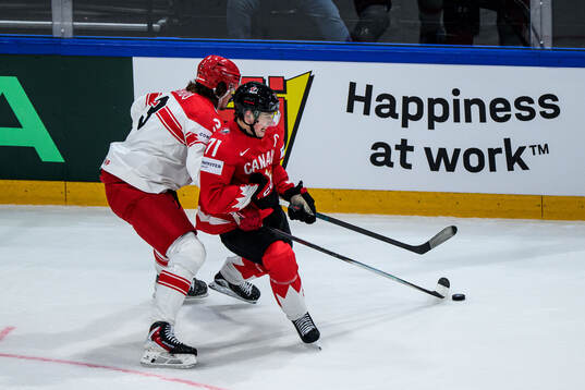 Malte Setkov of Denmark and Macklin Celebrini of Canada