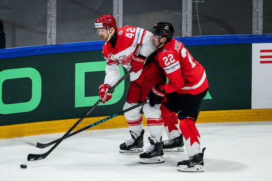 Phillip Bruggisser of Denmark and Evan Bouchard of Canada