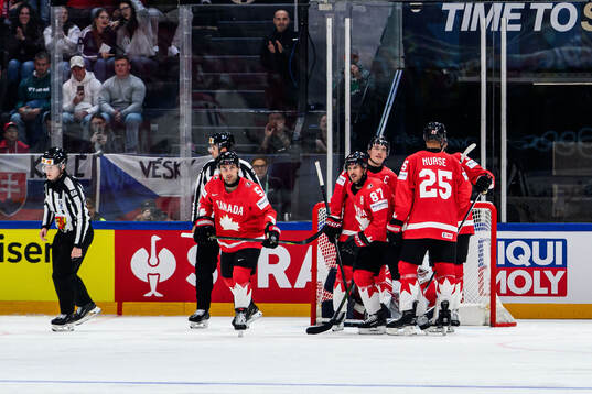 Denton Mateychuk and Sidney Crosby of Canada celebrates