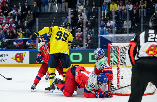 Jacob De La Rose of Sweden against goaltender Josef Korenar