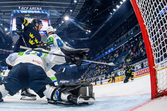 Lucas Raymond of Sweden (r) scores the 1-0 goal against