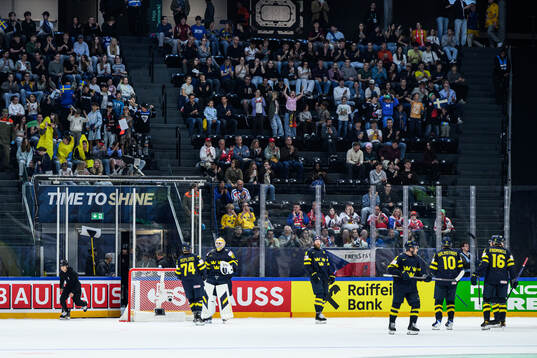 Rasmus Asplund and goaltender Arvid Söderblom of Sweden
