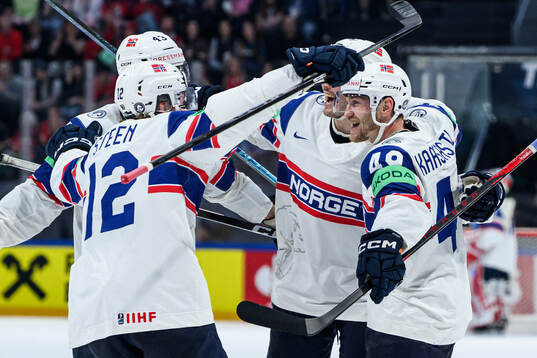 Christian Kåsastul of Norway (r) celebrates with teammates