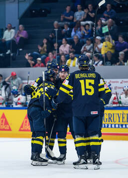 Carl Grundström of Sweden celebrates with team mates