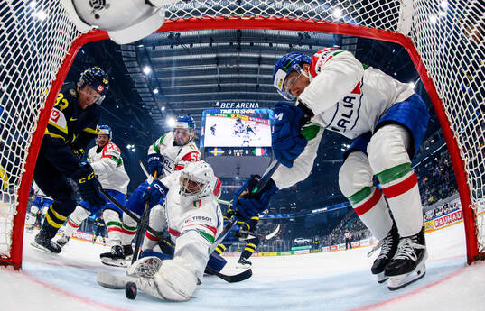 Jakob Silfverberg of Sweden compete for the puck with