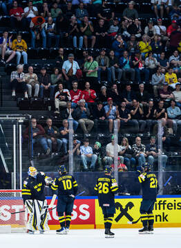 Goaltender Magnus Hellberg and Simon Holmström of Sweden